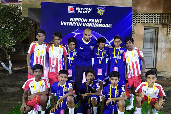 ISL Players line up with Football academy students.
